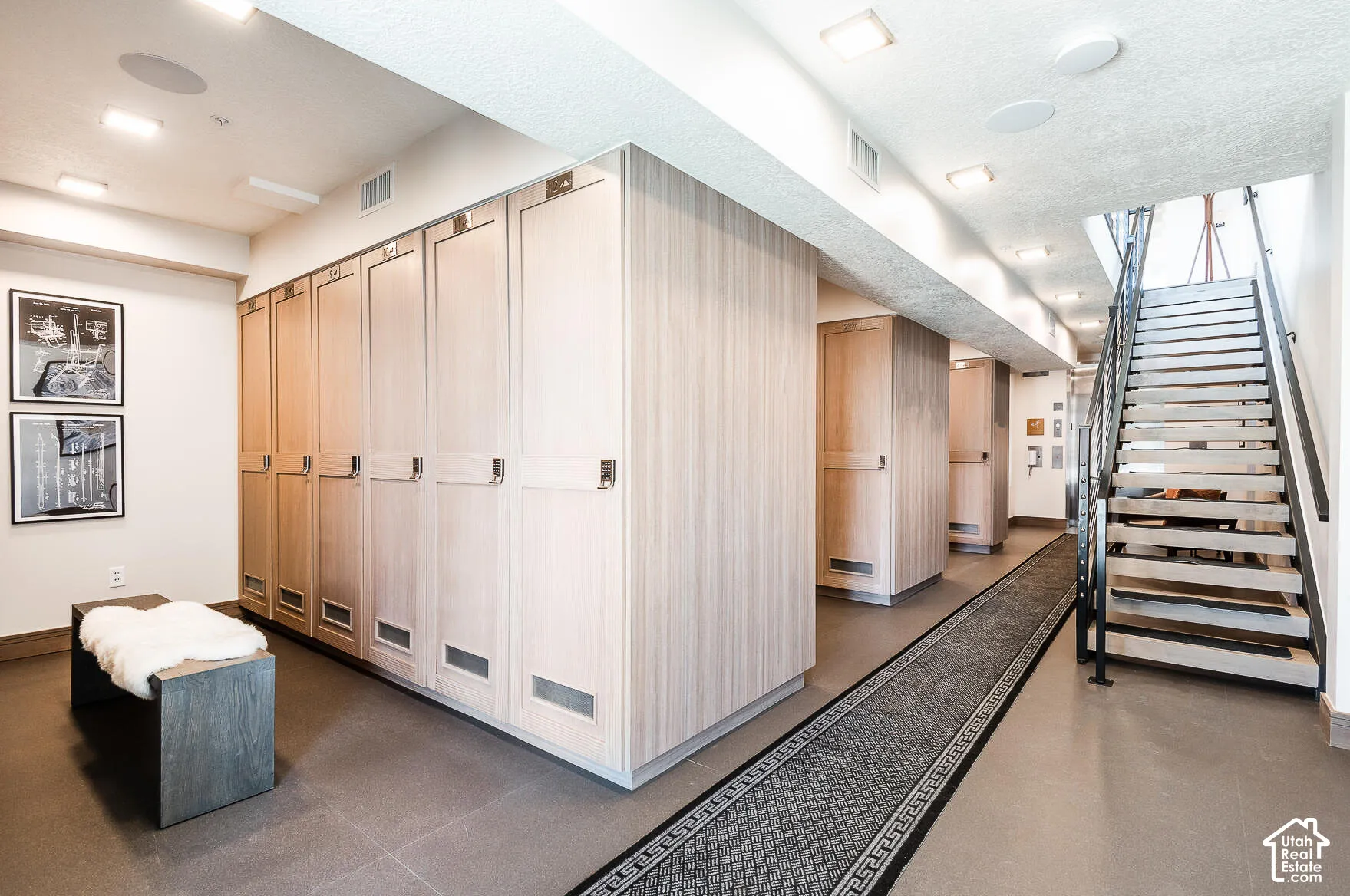 Integrated wood-finish cabinetry providing ample storage, complemented by recessed square lighting fixtures