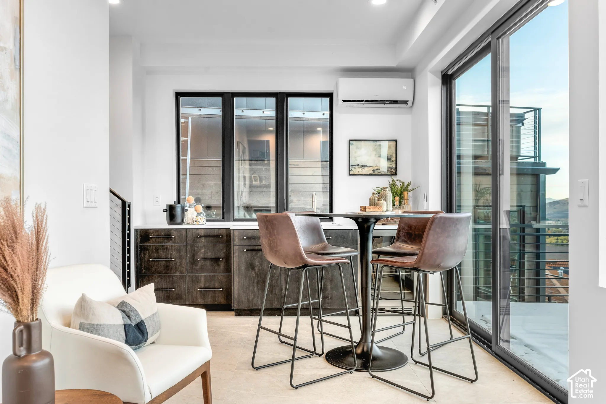 Integrated wet bar featuring dark wood-finish cabinetry and a light-colored countertop