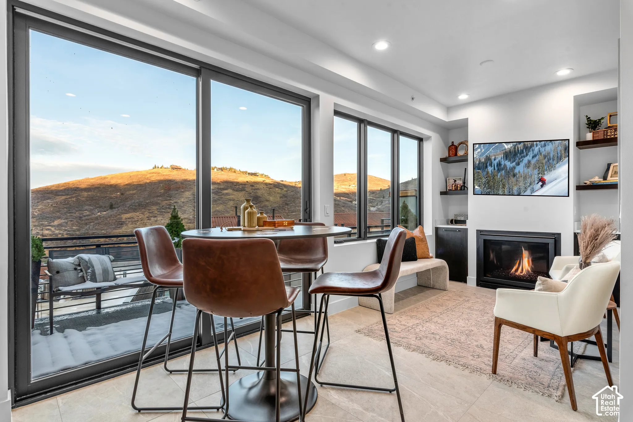 Expansive floor-to-ceiling sliding glass doors with a mountain backdrop