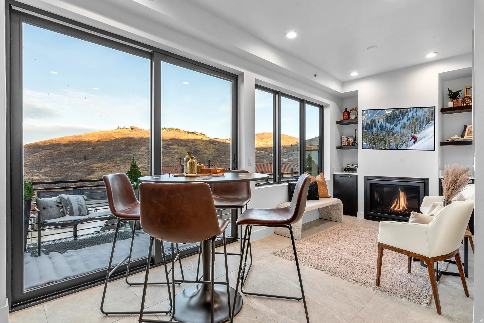 Expansive floor-to-ceiling sliding glass doors with a mountain backdrop