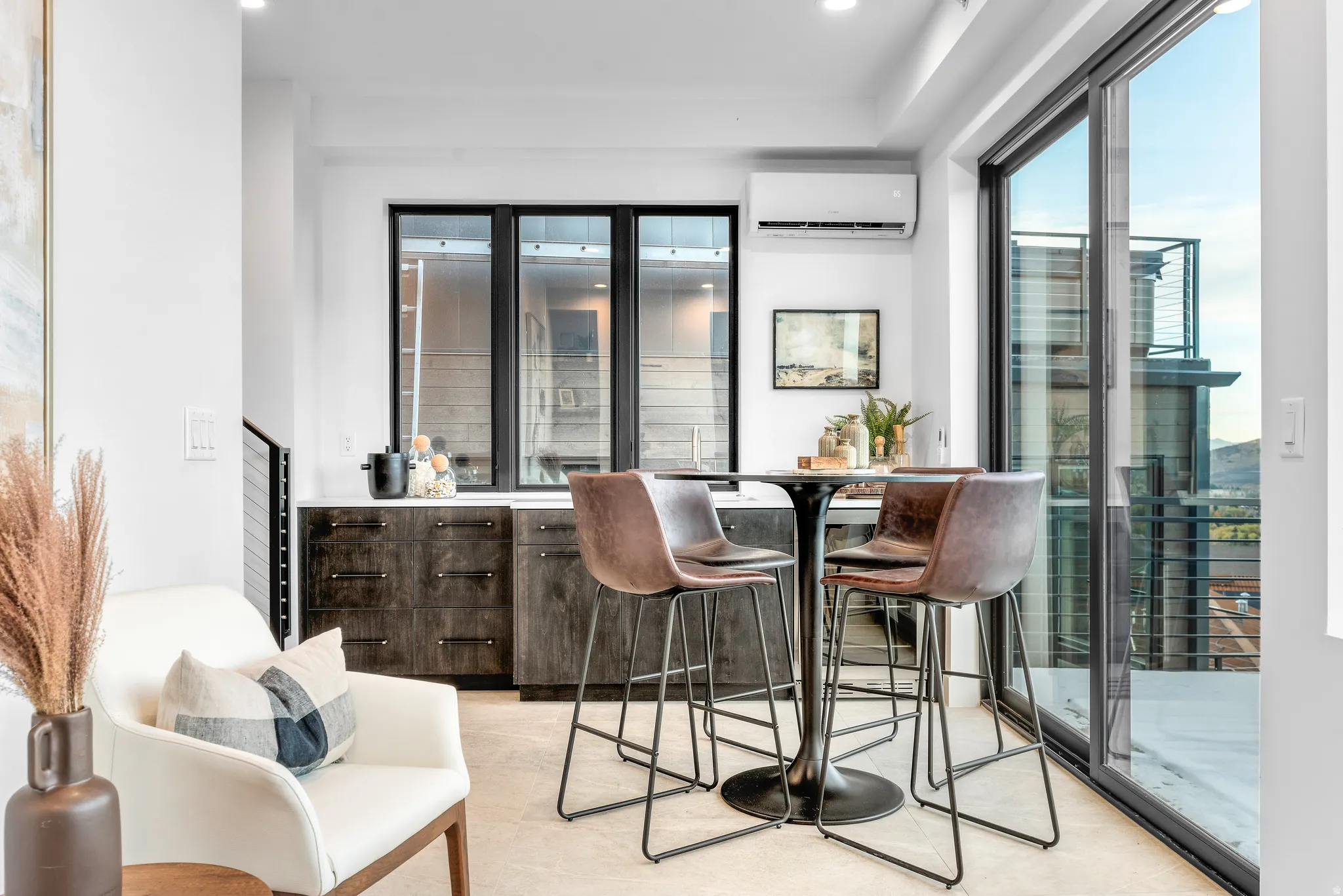 Integrated wet bar featuring dark wood-finish cabinetry and a light-colored countertop