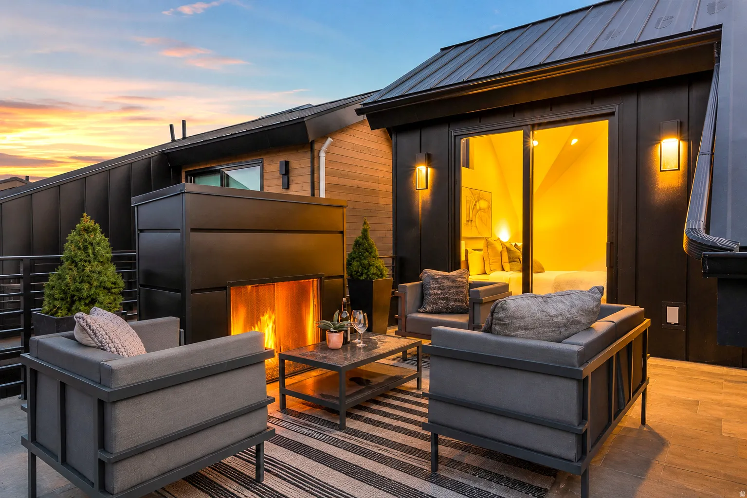 Rooftop patio featuring a modern fireplace and plank-style flooring