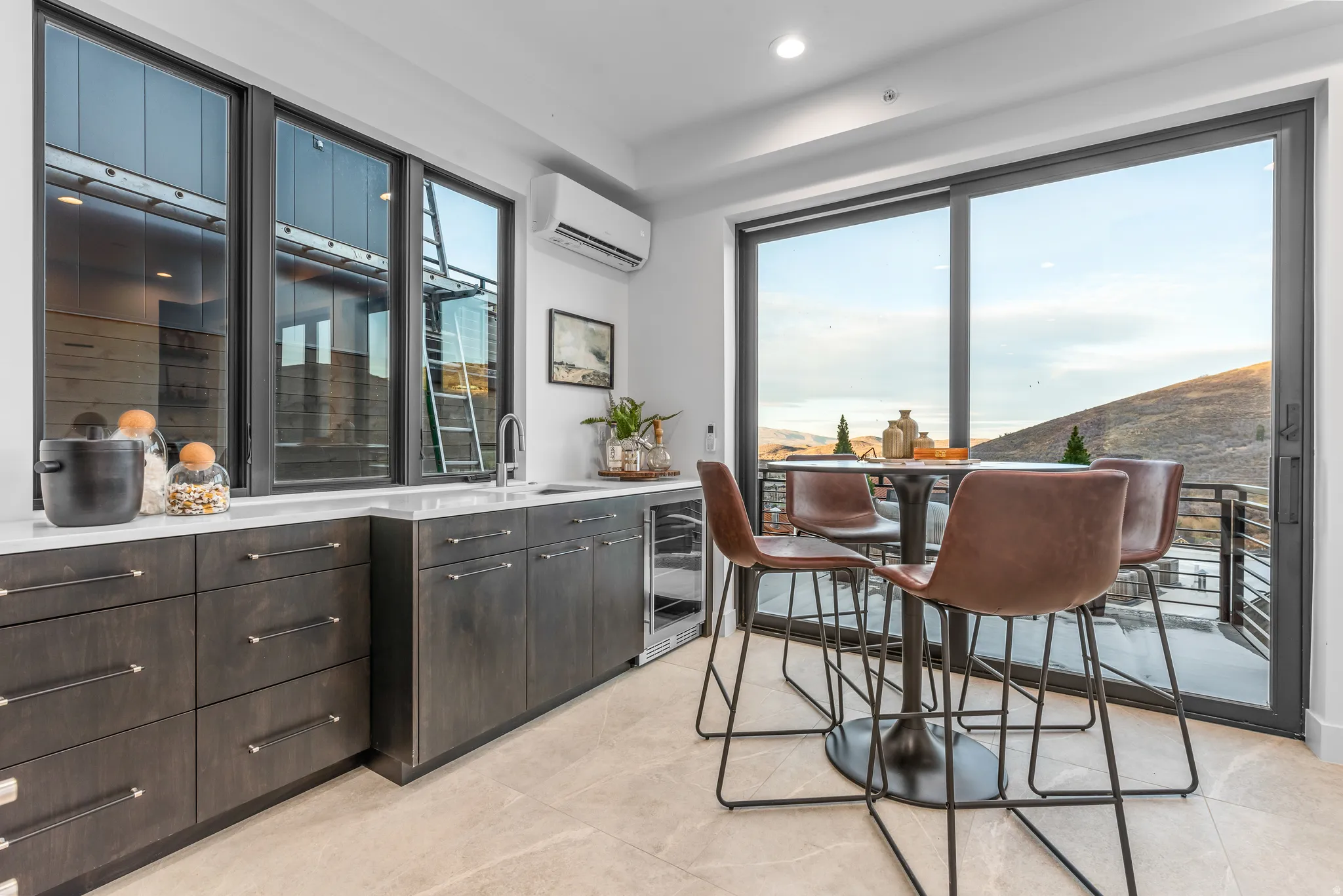 Wet bar featuring dark wood-finish cabinetry, a white countertop, a built-in beverage refrigerator, and a stainless steel sink with a gooseneck faucet