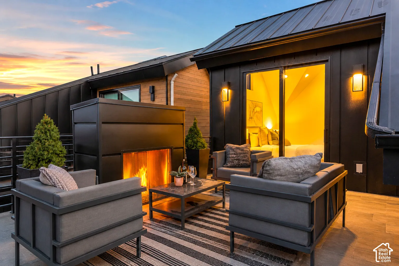 Rooftop patio featuring a modern fireplace and plank-style flooring
