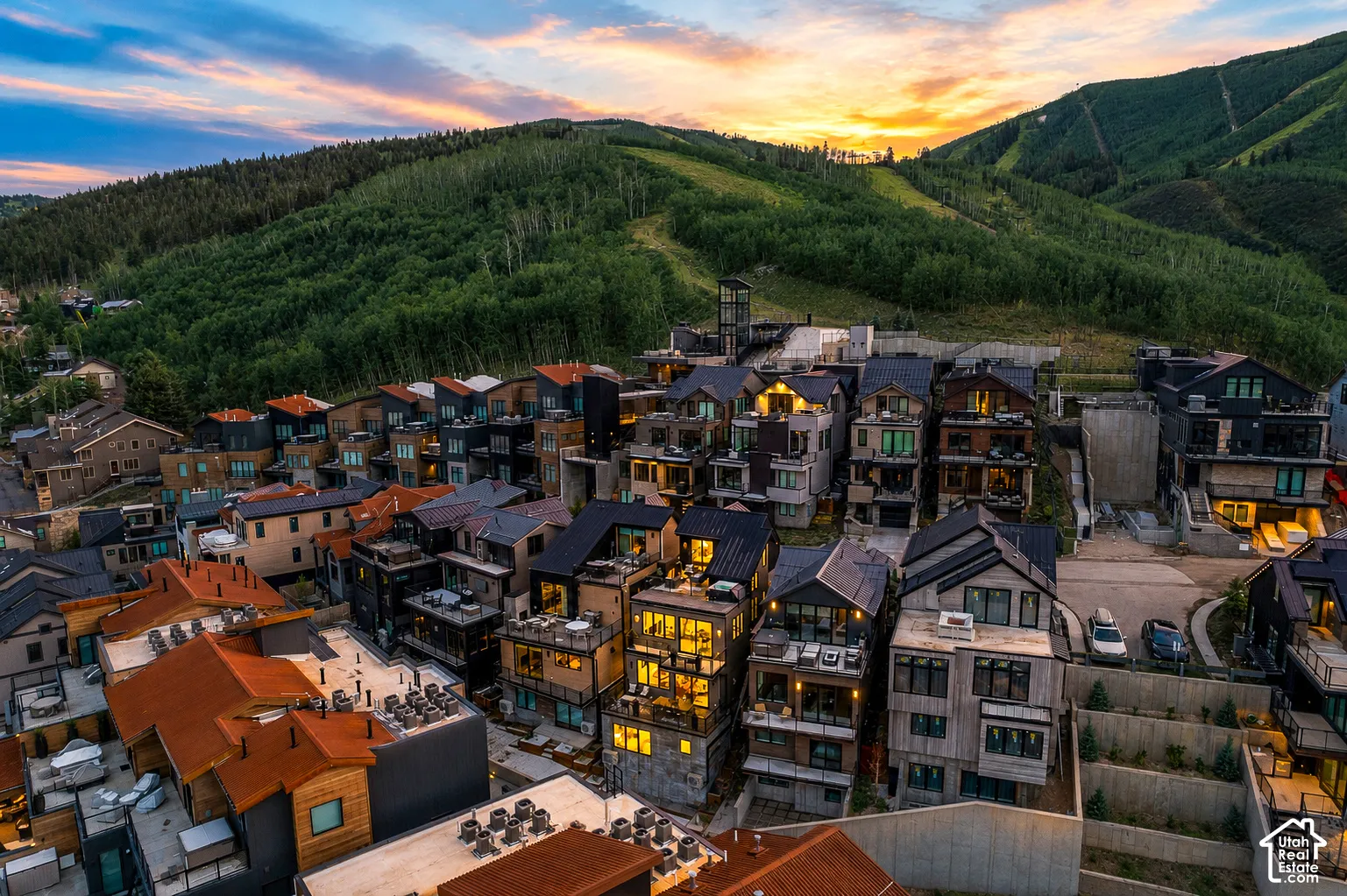 Multi-level residential development with diverse architectural styles, featuring pitched and flat roofs