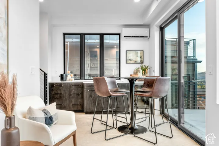 Integrated wet bar featuring dark wood-finish cabinetry and a light-colored countertop