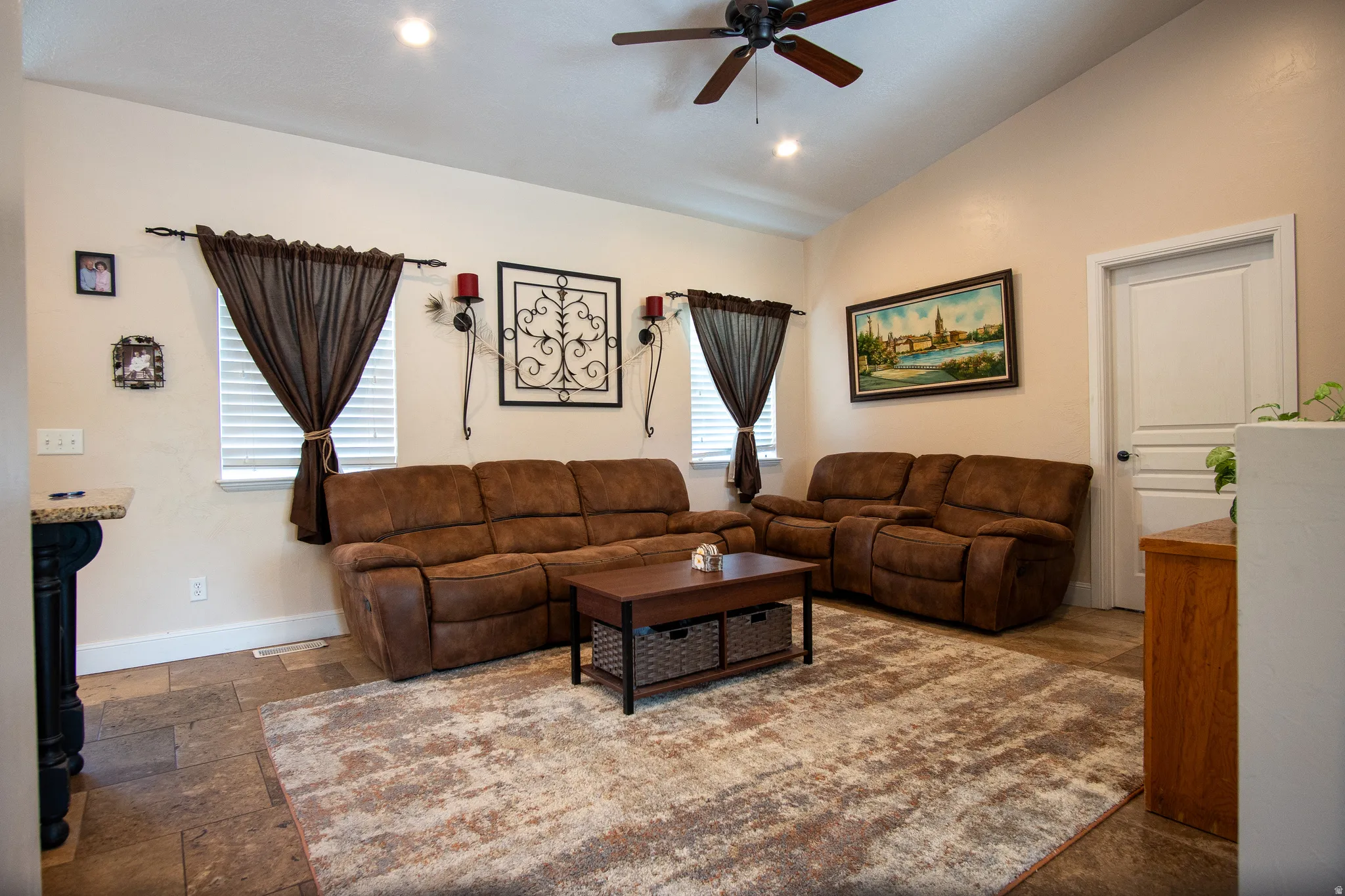 Living area featuring vaulted ceilings, recessed lighting, and a ceiling fan