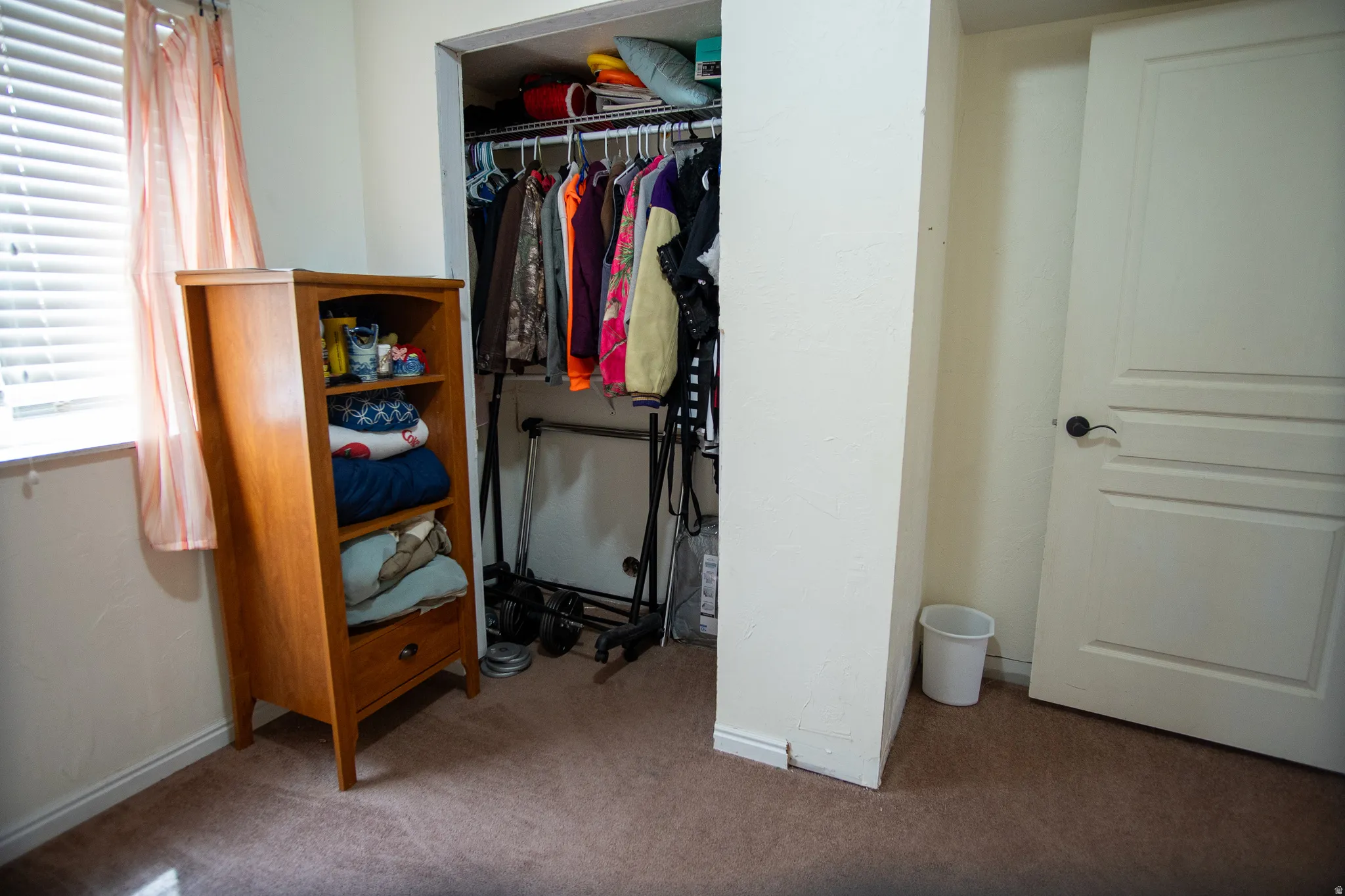 Open closet featuring a clothes rod for hanging storage and an upper shelf