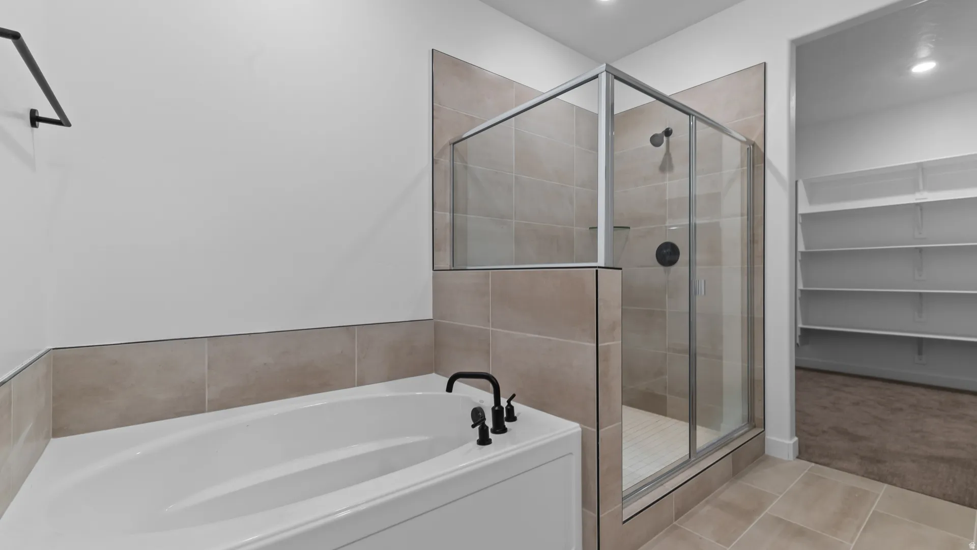 Contemporary bathroom featuring a built-in tub, a glass-enclosed shower, and coordinating tile flooring