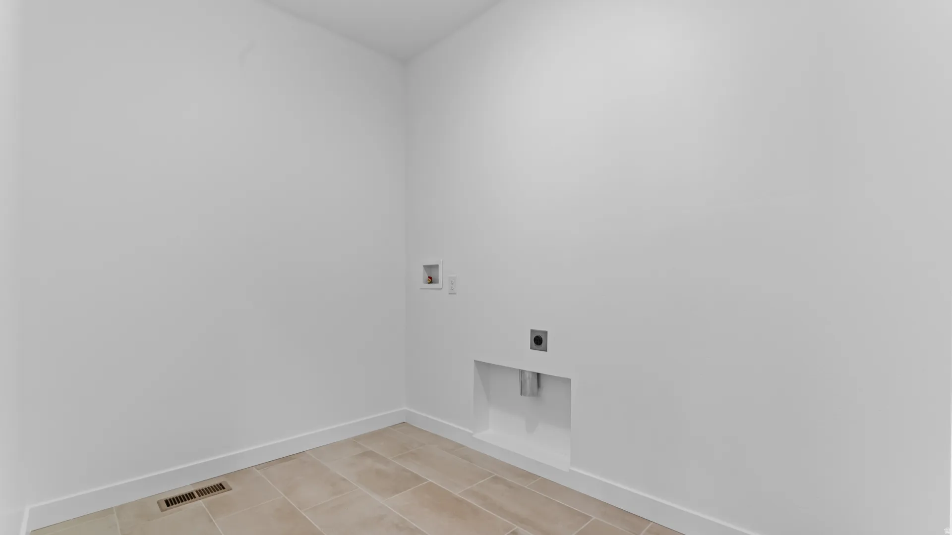 Laundry area with light-toned tiled flooring and crisp white walls