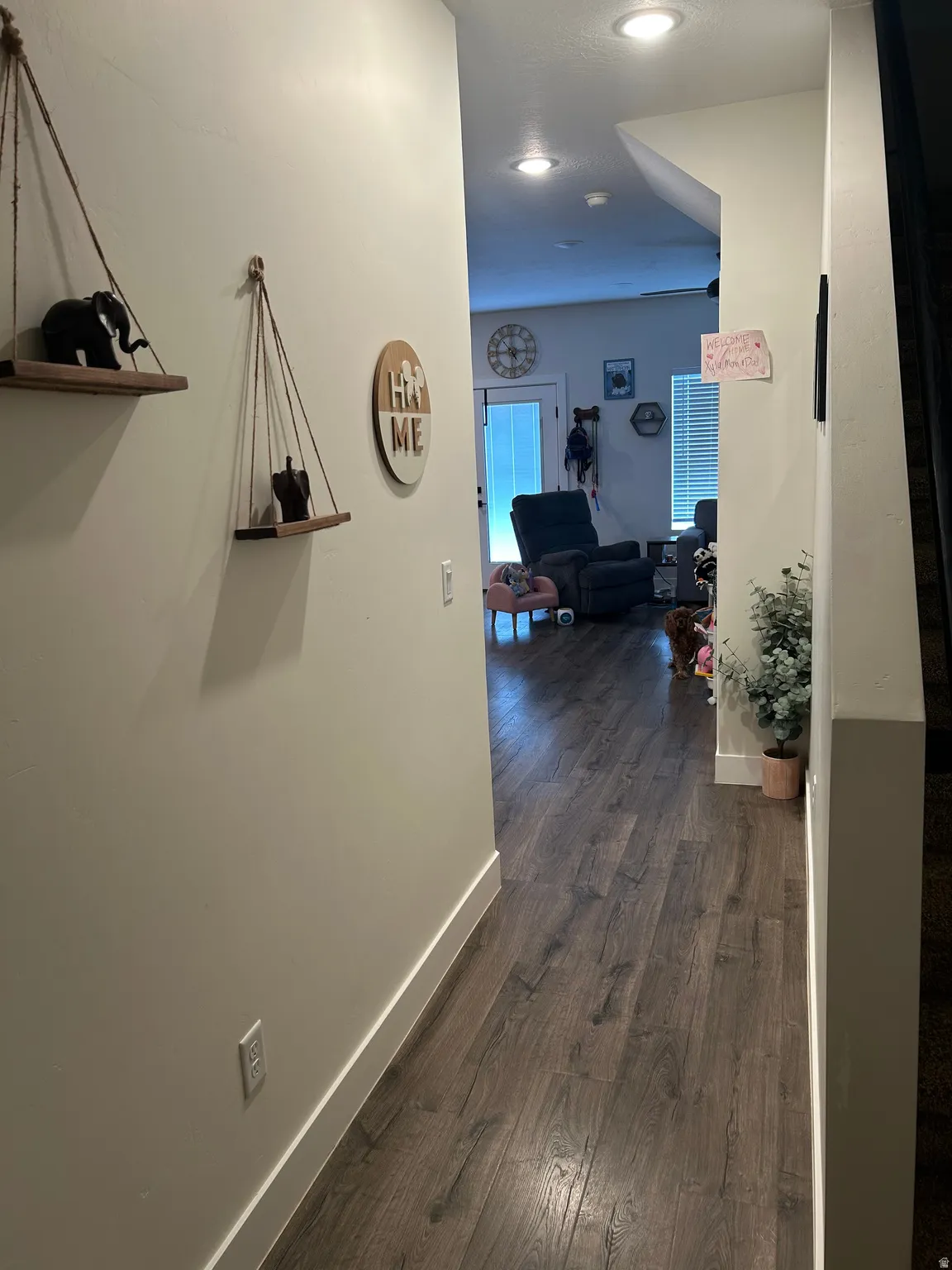 Hallway featuring wood-finish flooring, recessed lighting, and white baseboards