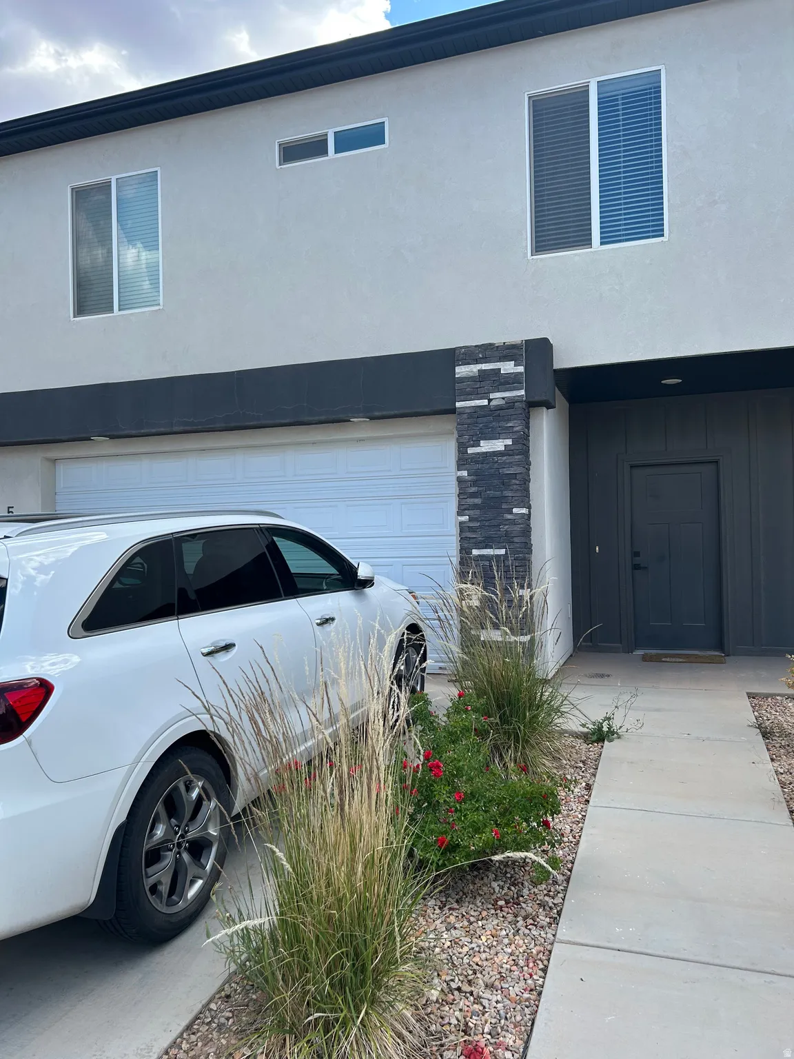 Modern stucco exterior with stone veneer accents