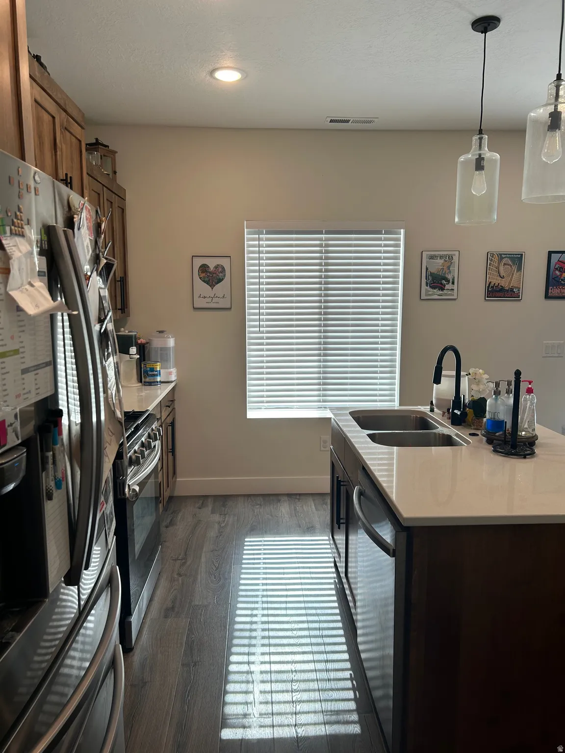 Kitchen featuring wood-finish flooring, recessed lighting, and a window with blinds