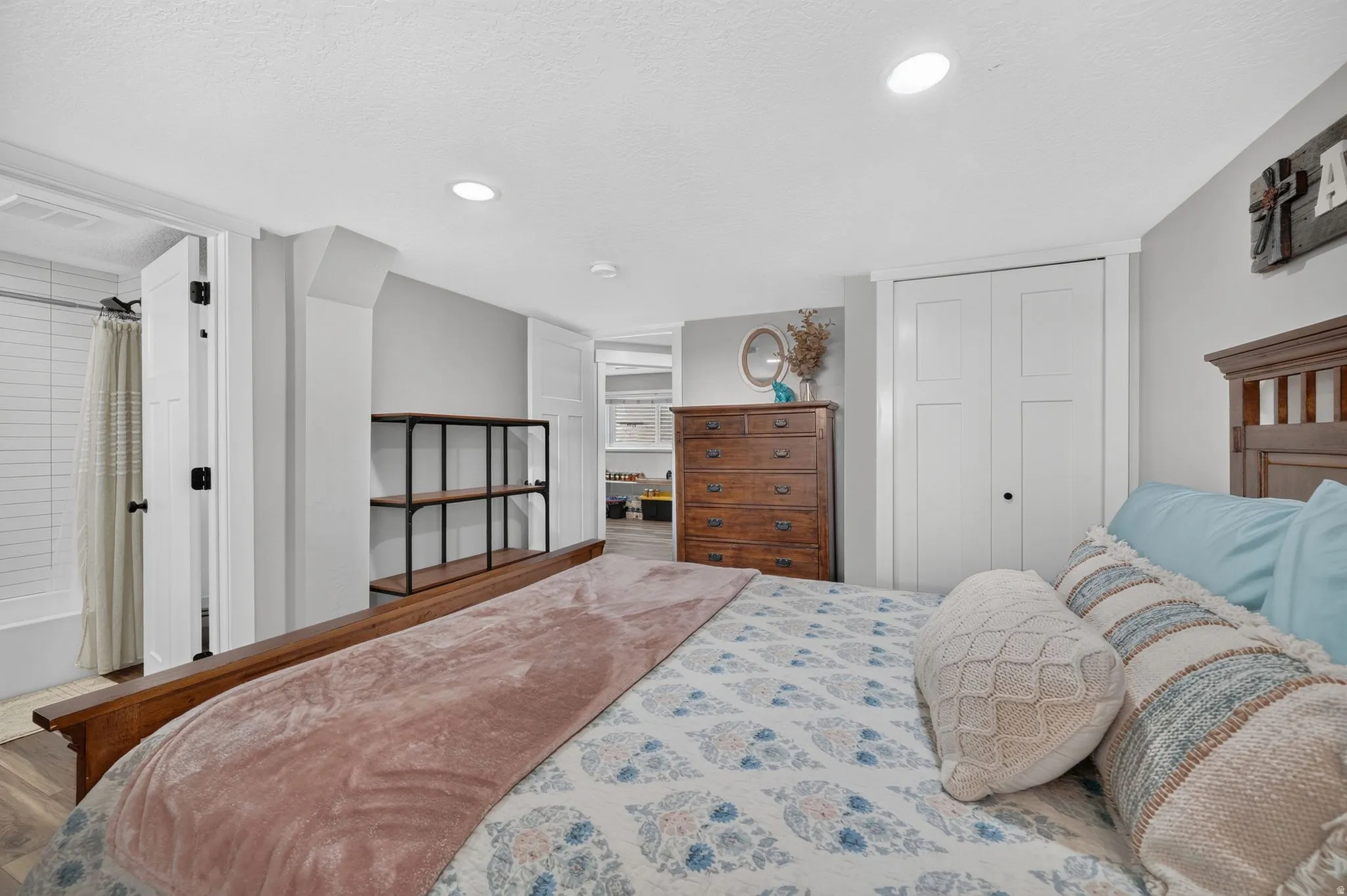 Bedroom featuring wood-finish flooring, recessed lighting, and a built-in shelving unit