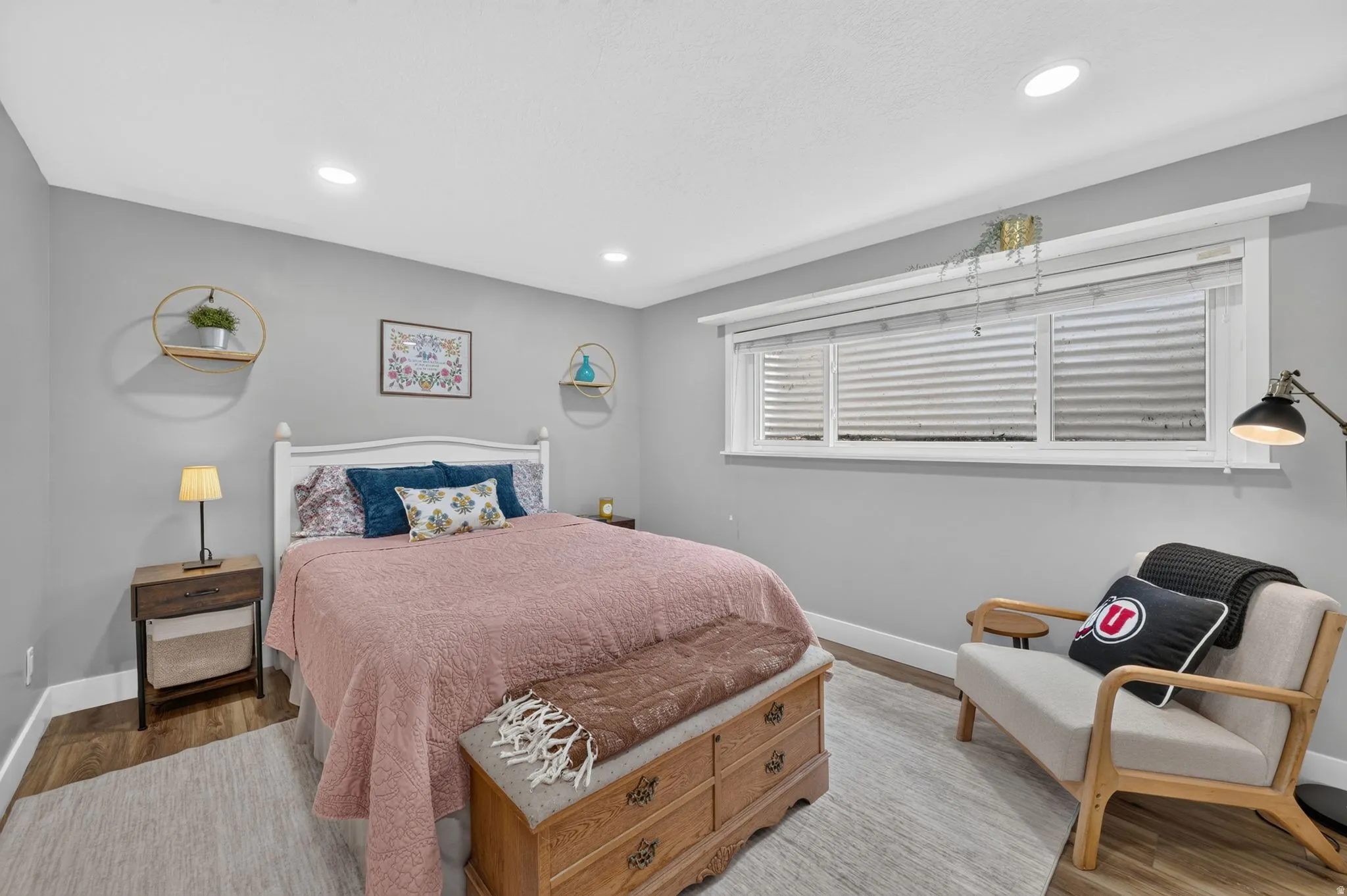 Bedroom featuring wood-finish flooring, recessed lighting, and a wide window with white blinds