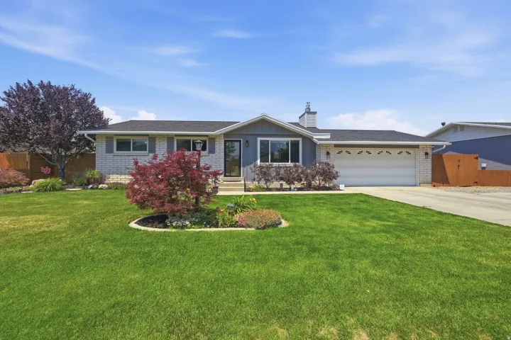 Ranch-style residence featuring a prominent two-car garage