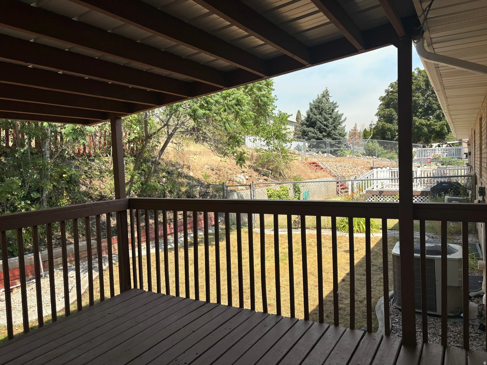 Expansive wood deck with a full railing and slatted wood flooring
