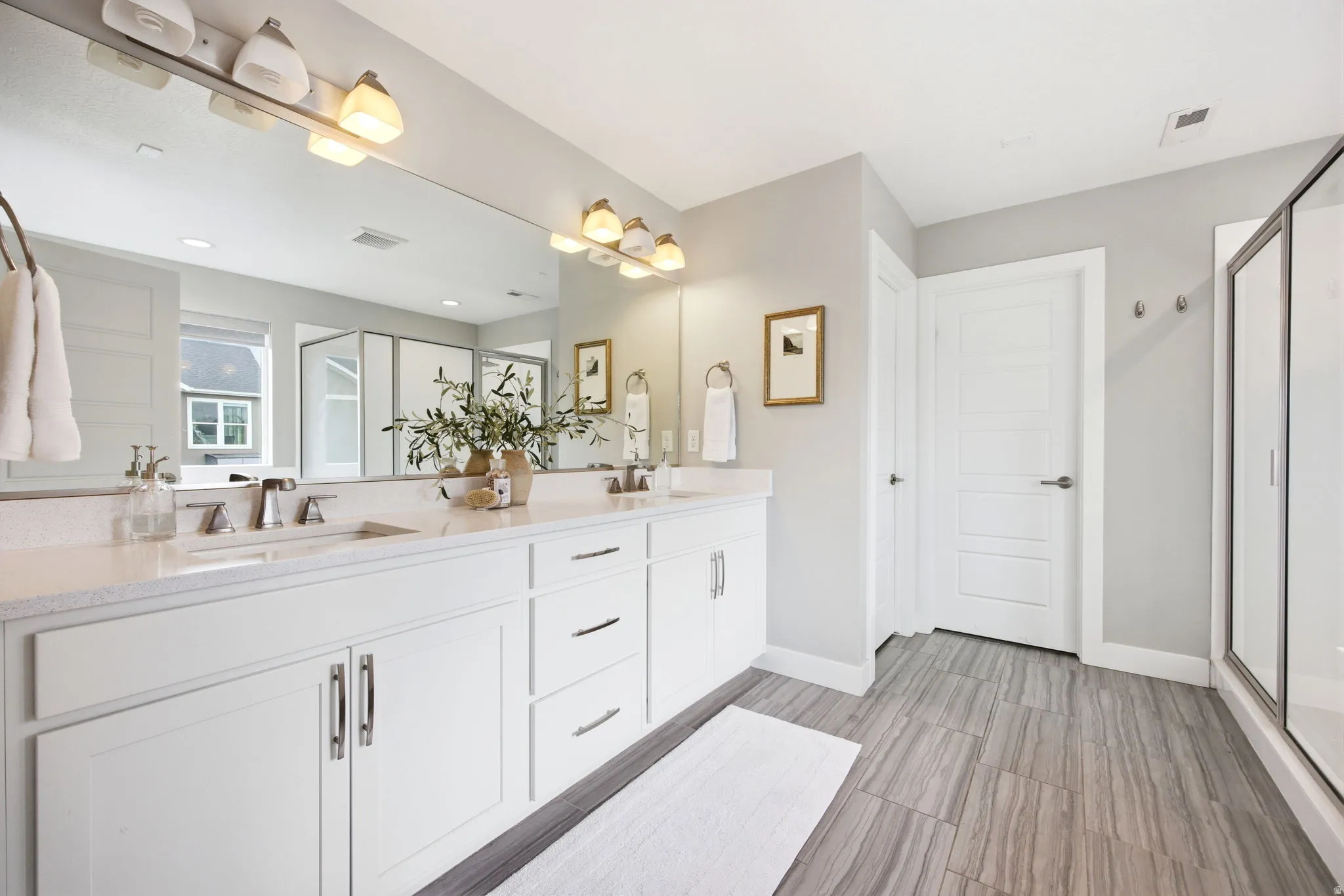 Double vanity featuring stone countertops and two undermount sinks