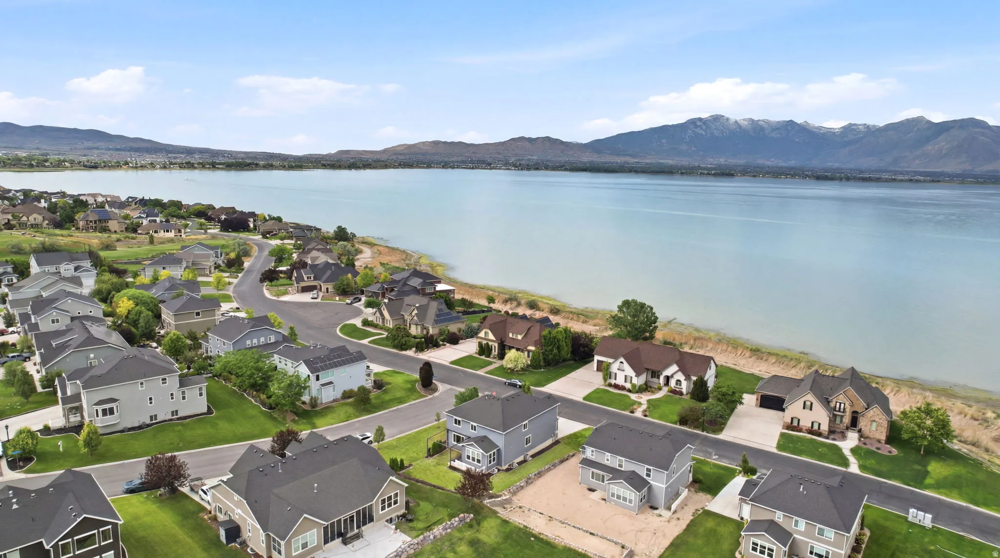 Expansive waterfront community featuring varied architectural styles and mountain scenery