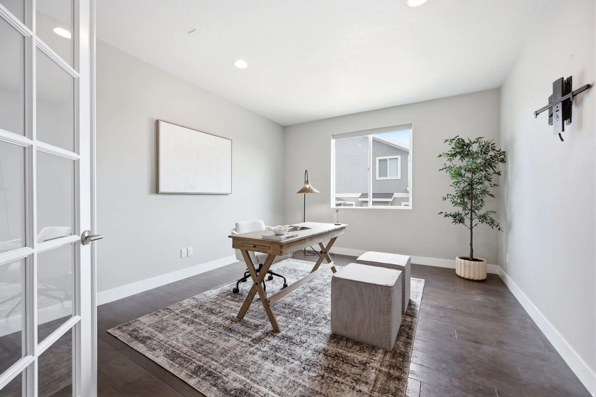 Room featuring French doors with glass panes, recessed lighting, a window, dark wood-finish flooring, and light gray walls