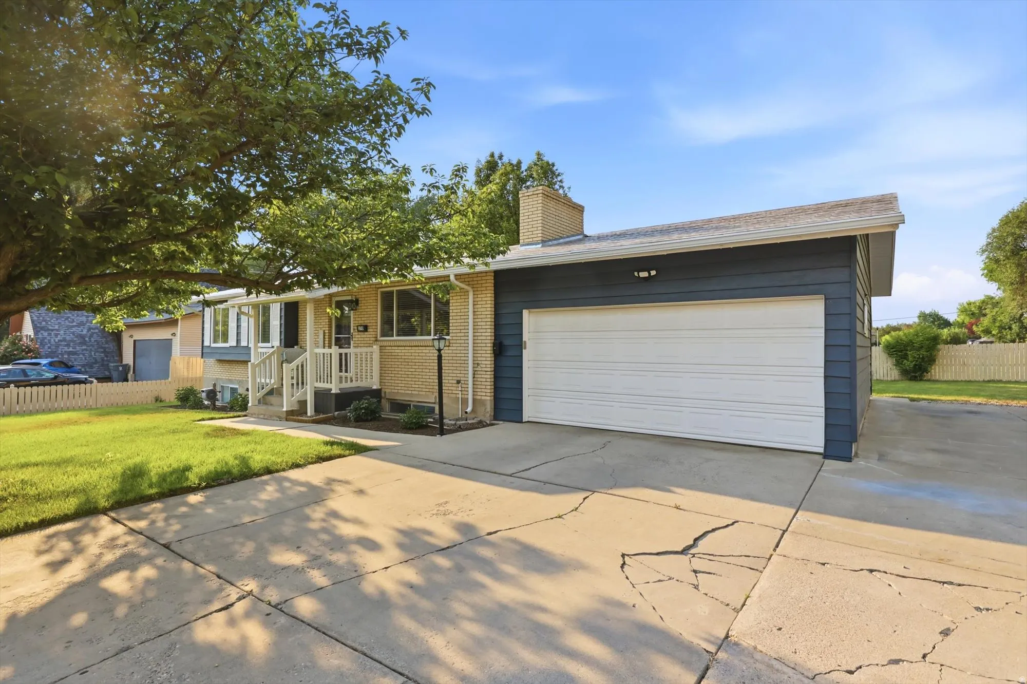 Exterior featuring a light brick facade and dark blue horizontal siding