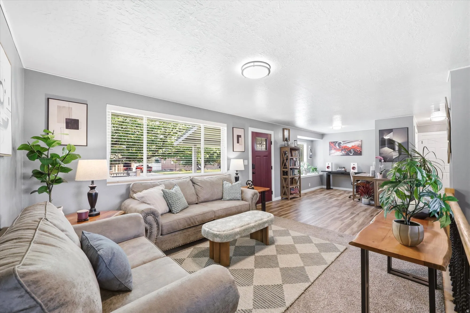 Spacious living area featuring carpet and wood-finish flooring