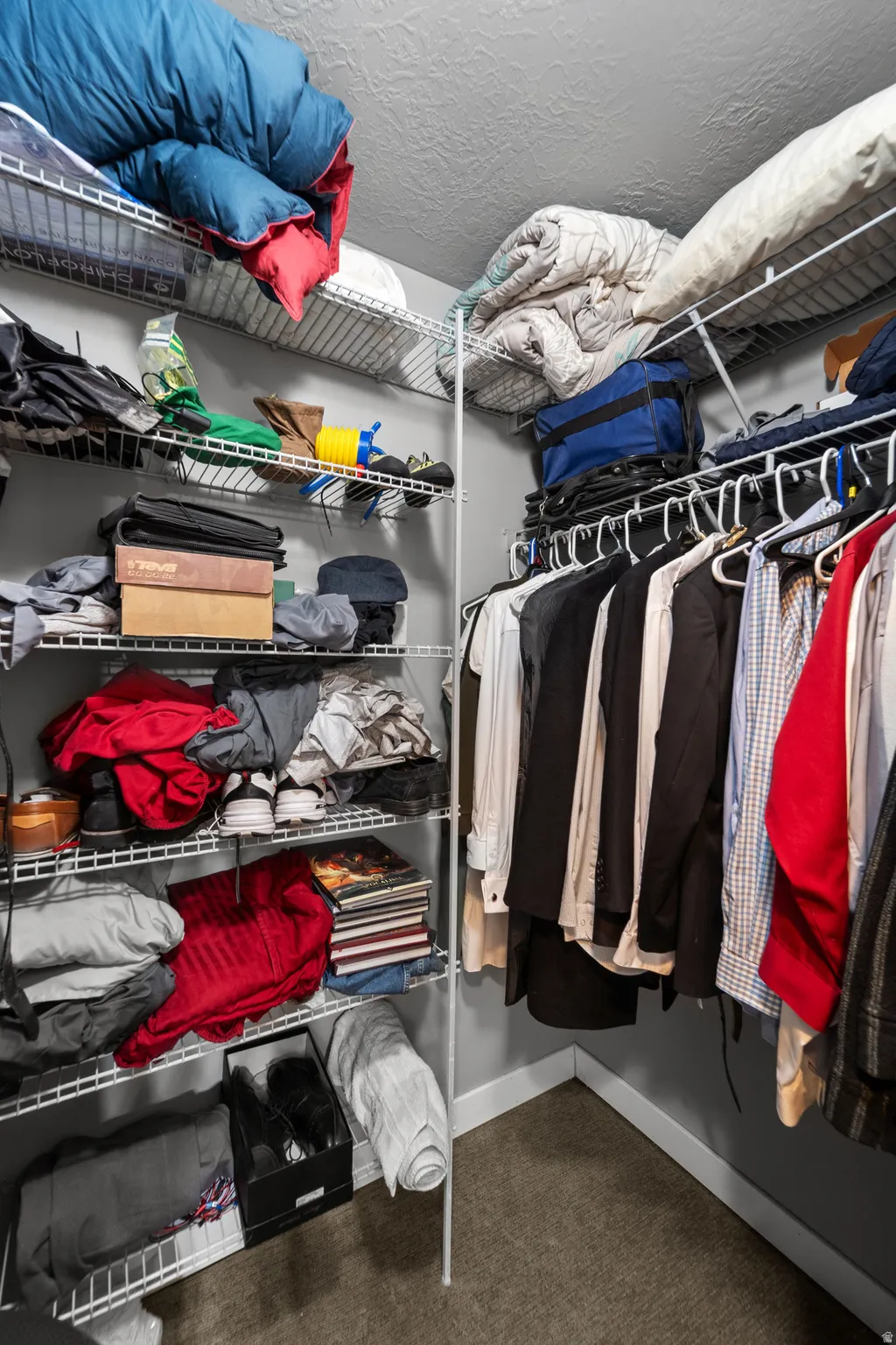 The walk in closet is double sided and has a large shelf system in the back.
