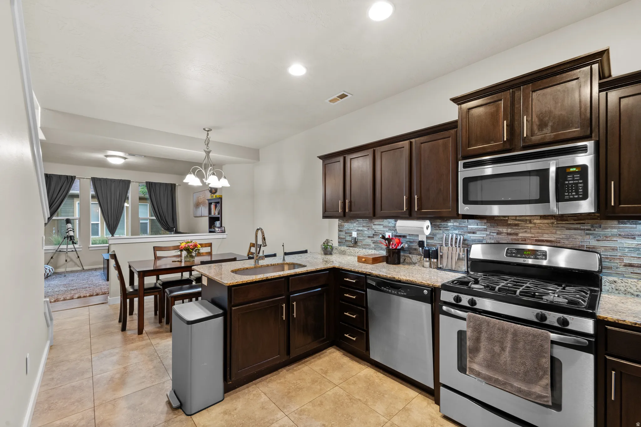The kitchen offers granite countertops, stainless steel appliances, and ample storage. You'll be cooking up your favorite meals on the gas range!