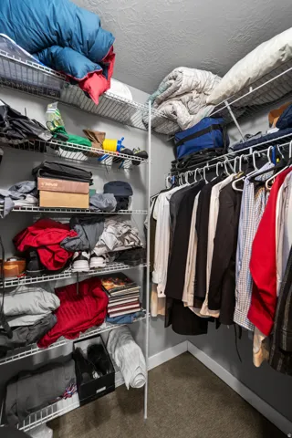 The walk in closet is double sided and has a large shelf system in the back.