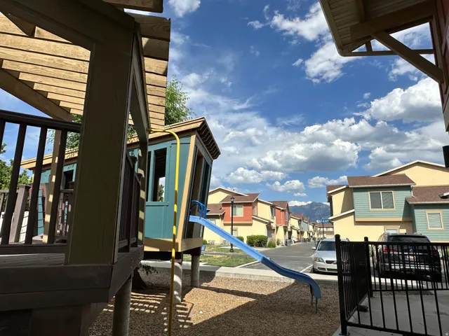 Community play structure with a slide and elevated platform