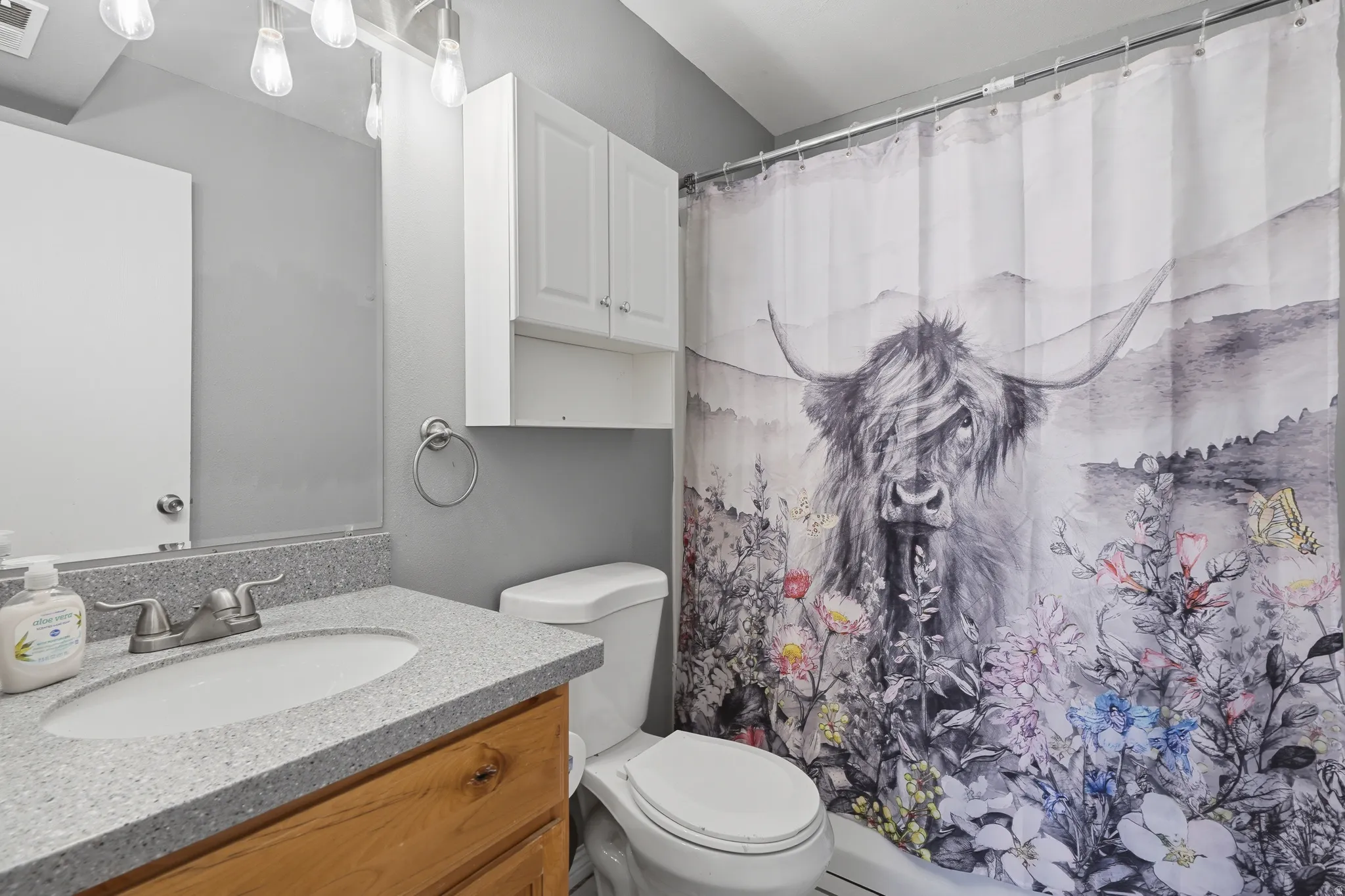 Bathroom vanity with a light-toned countertop and an undermount sink