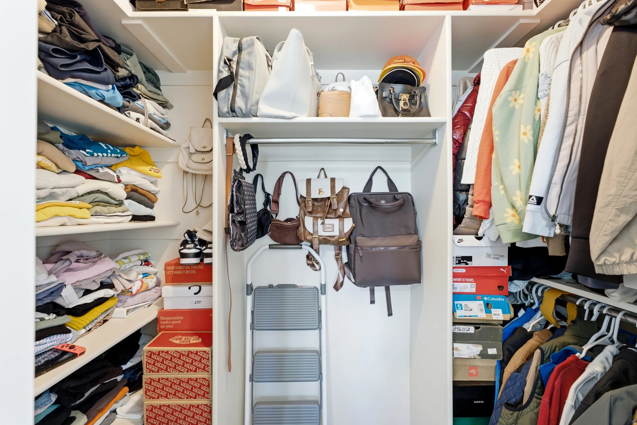 Built-in closet system featuring multiple shelving units, integrated hanging rods, and ample storage compartments