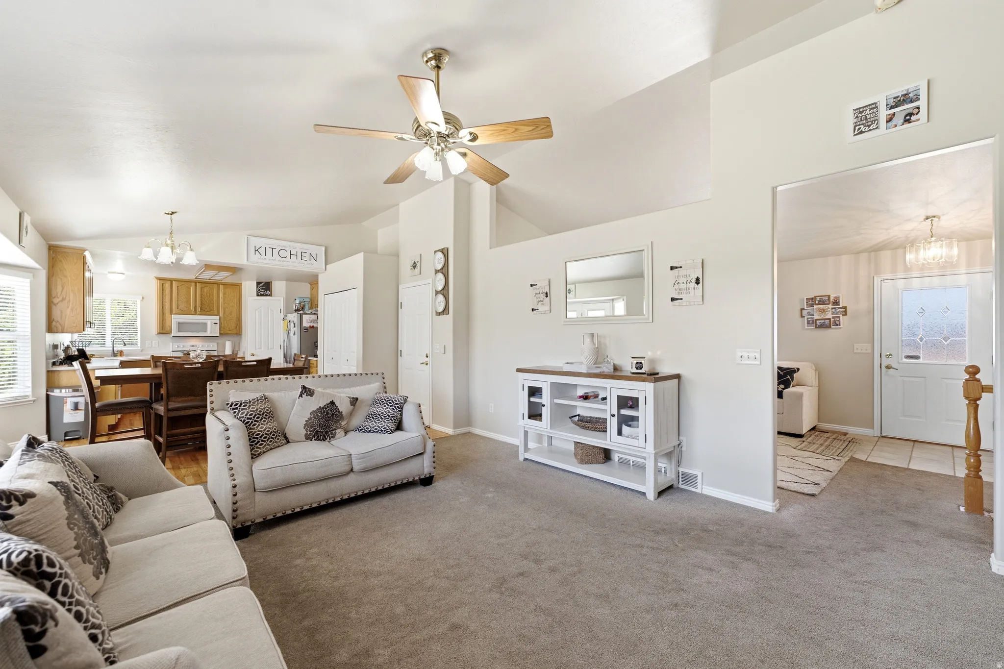 Vaulted ceilings and a ceiling fan enhance the living area