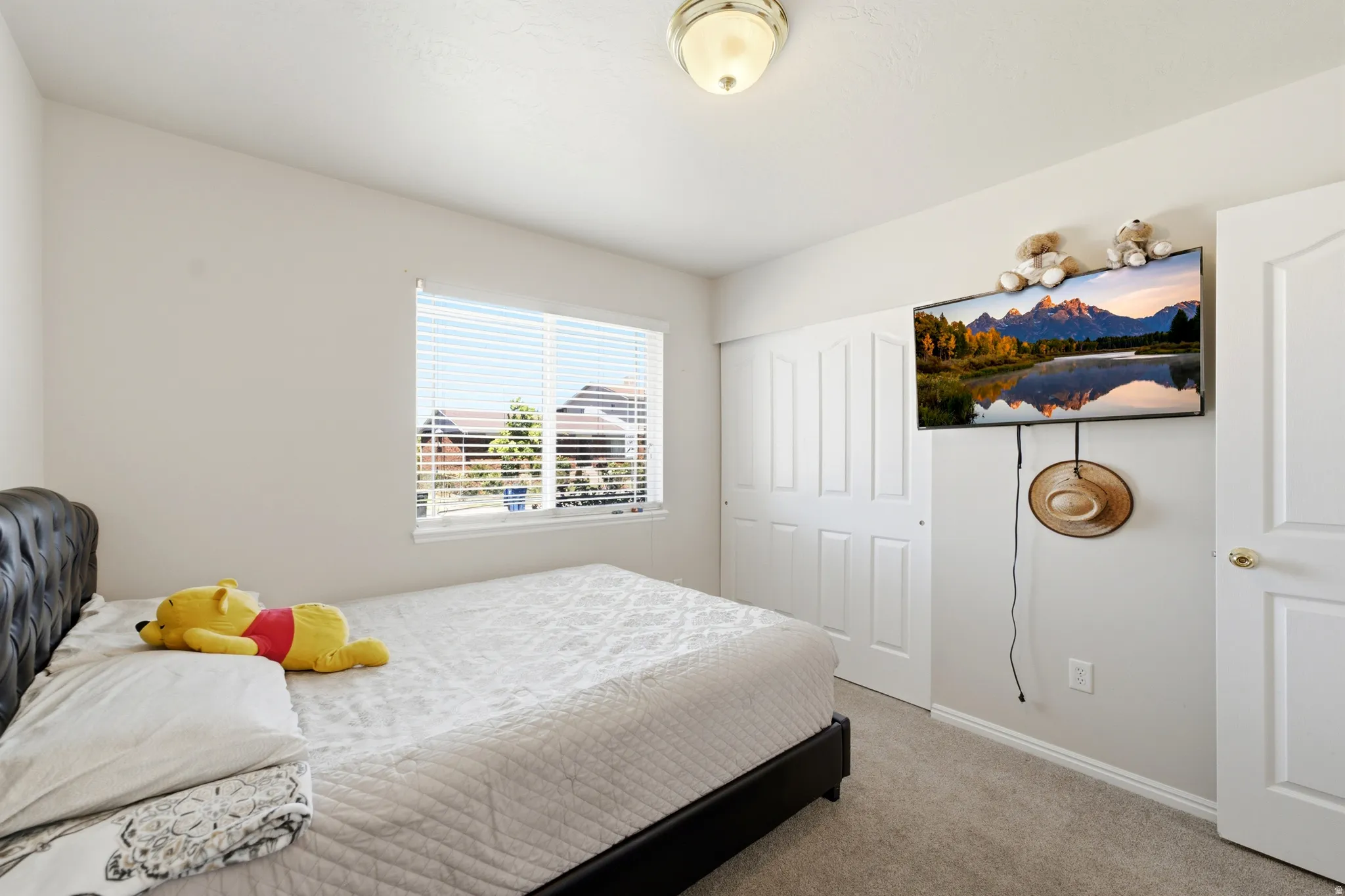 Interior room featuring light gray carpeting and white walls