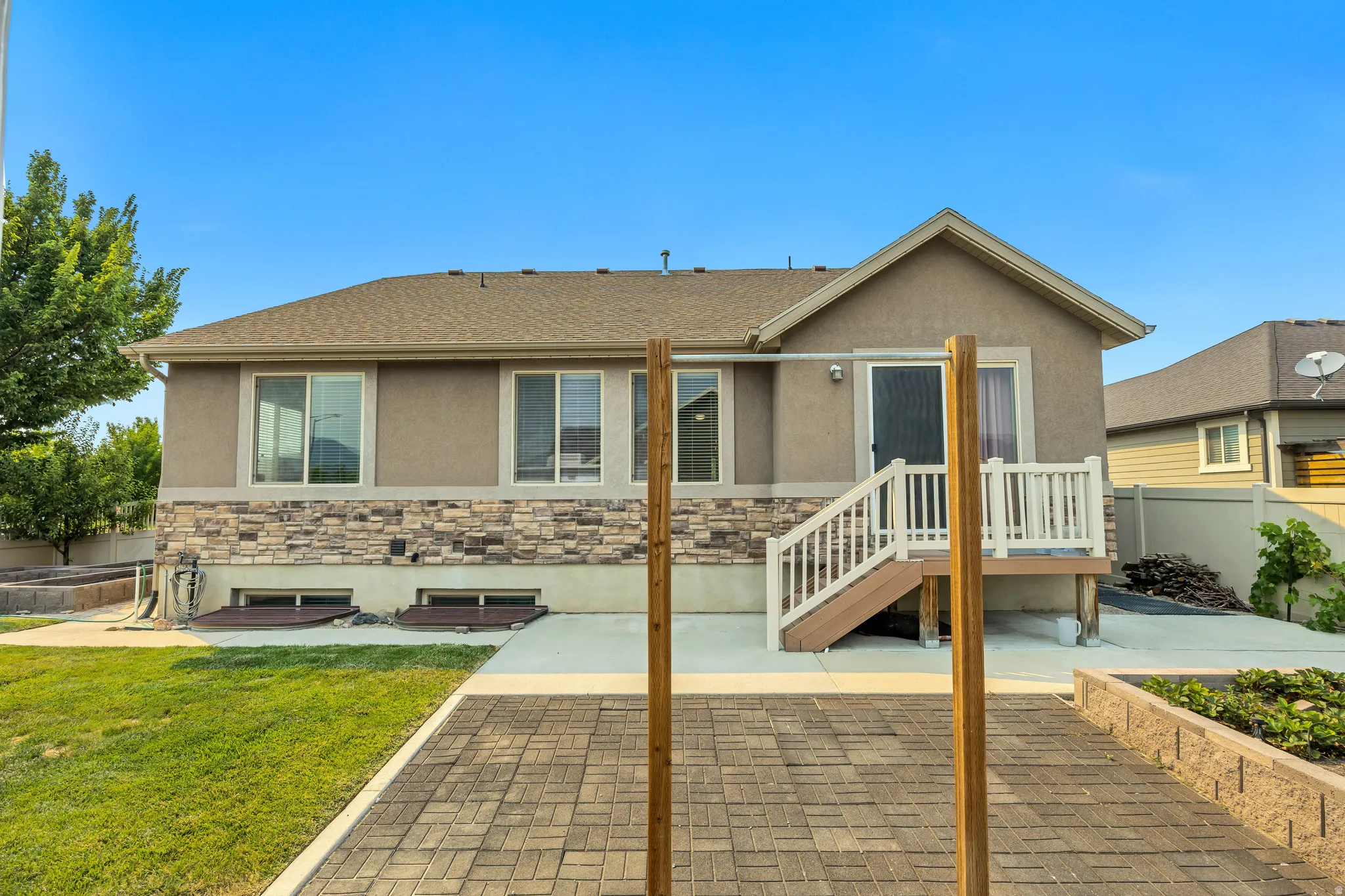 Rear exterior featuring stucco and stone veneer siding