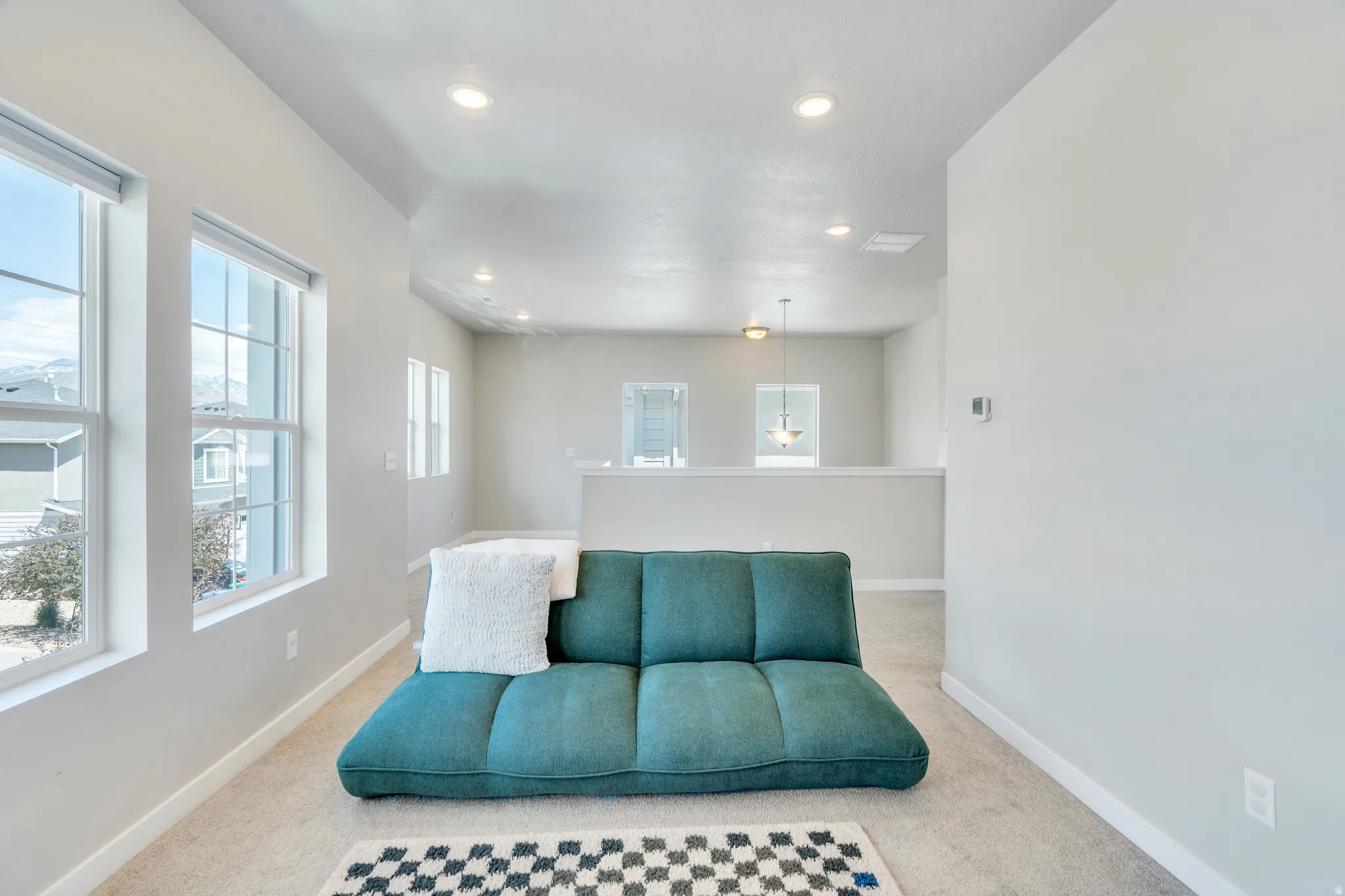 Open room featuring carpet flooring and light-toned walls