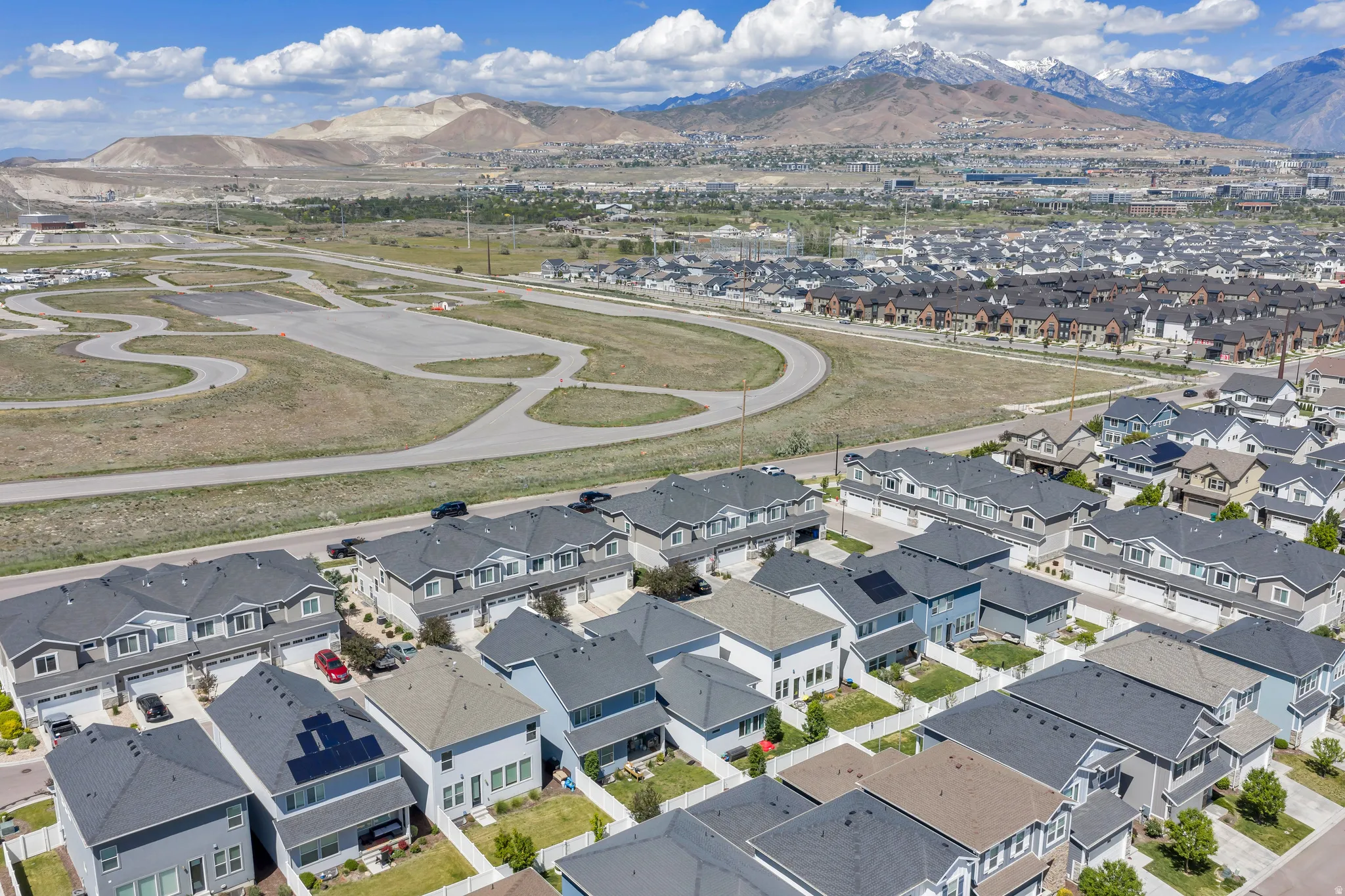 Aerial perspective showcasing a modern residential neighborhood with a mountain backdrop