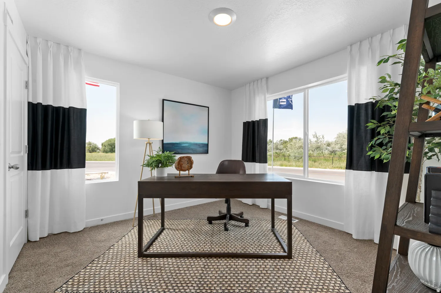 Bright interior room featuring a large double window and a single window