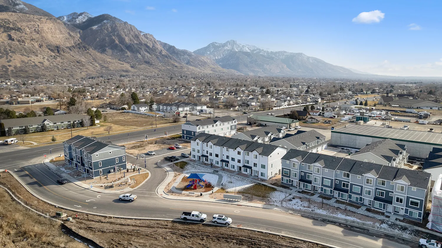Newly constructed townhome community with varied exterior finishes and attached garages