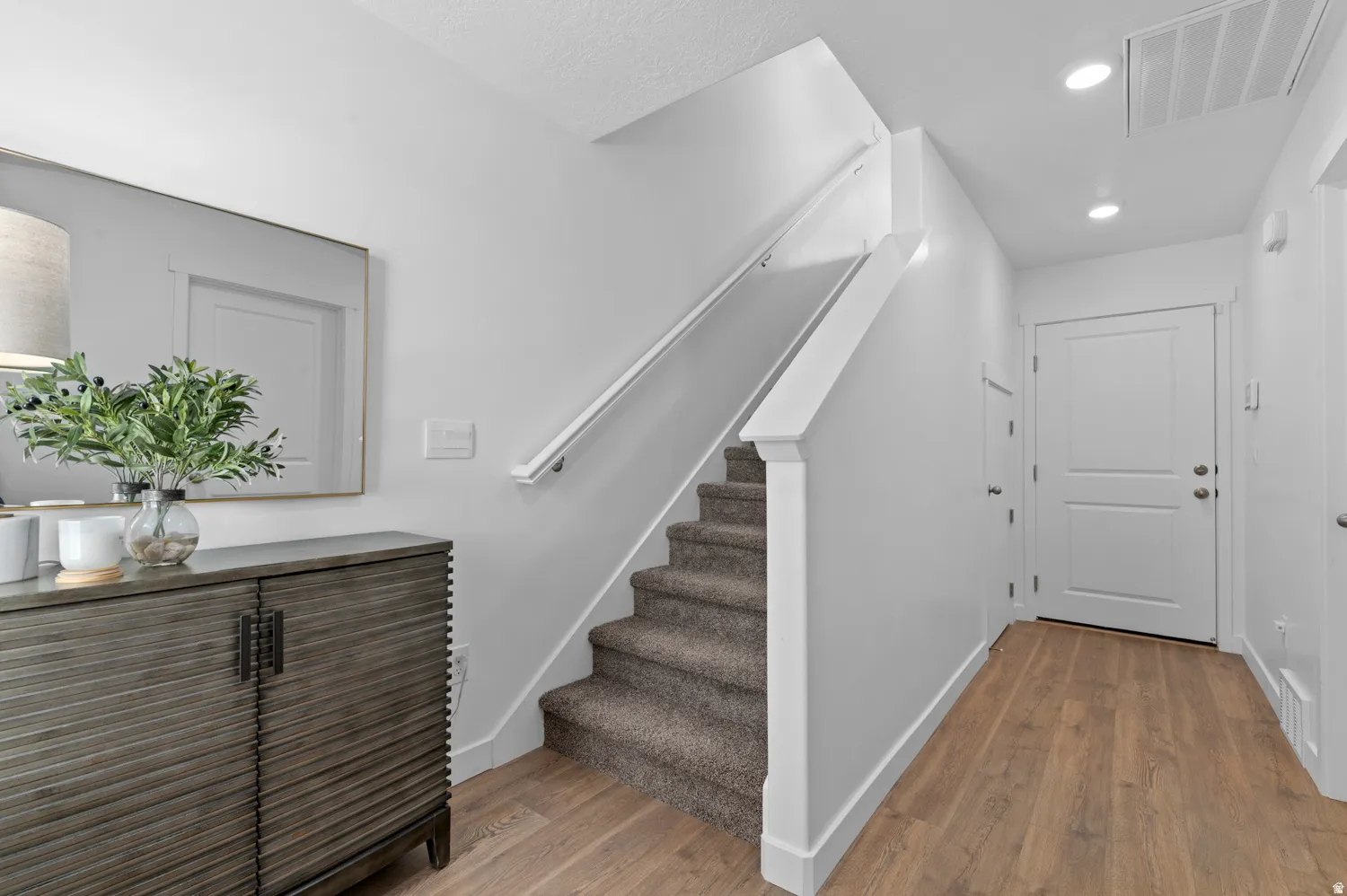 Laminate wood-finish flooring provides a durable surface throughout the entry
