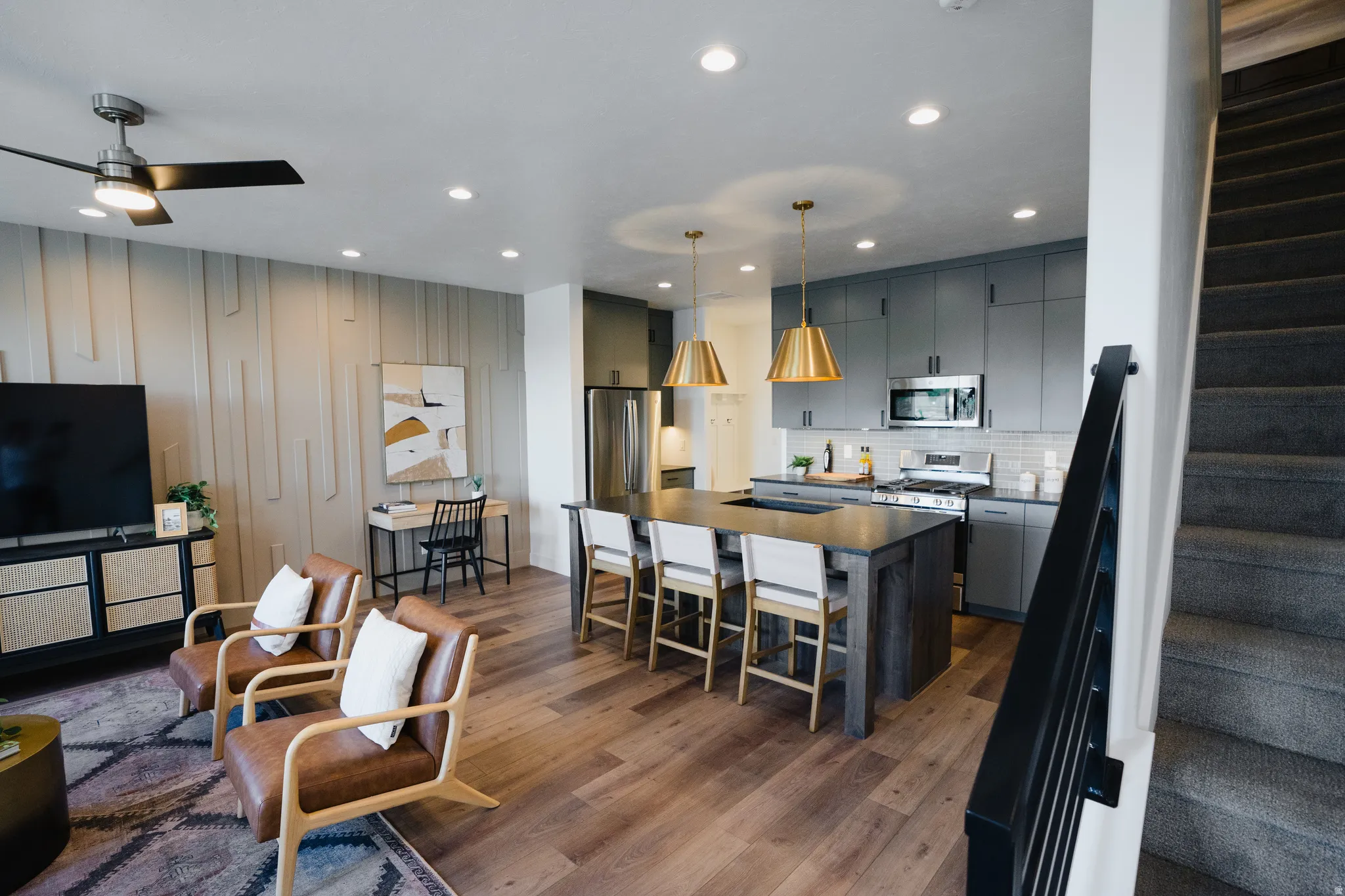 Open-concept living space with wood-finish flooring