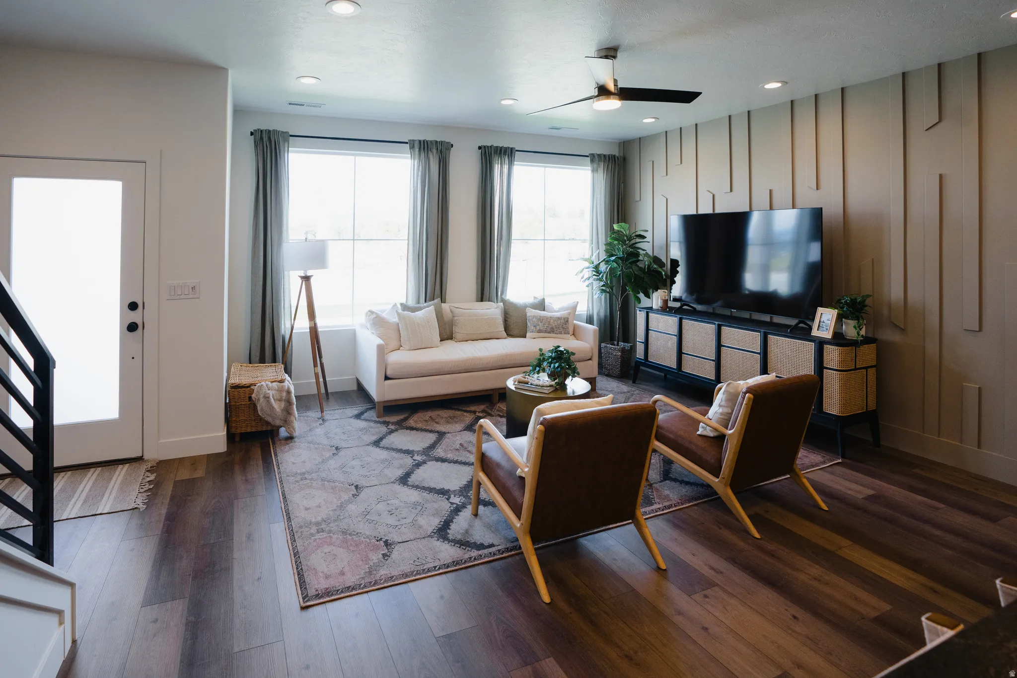 Spacious living area featuring wood-finish flooring, recessed lighting, and a modern ceiling fan