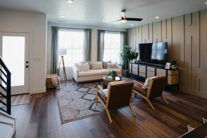 Spacious living area featuring wood-finish flooring, recessed lighting, and a modern ceiling fan