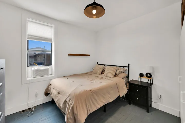 Interior room with light-toned walls and blue-painted wood-finish flooring
