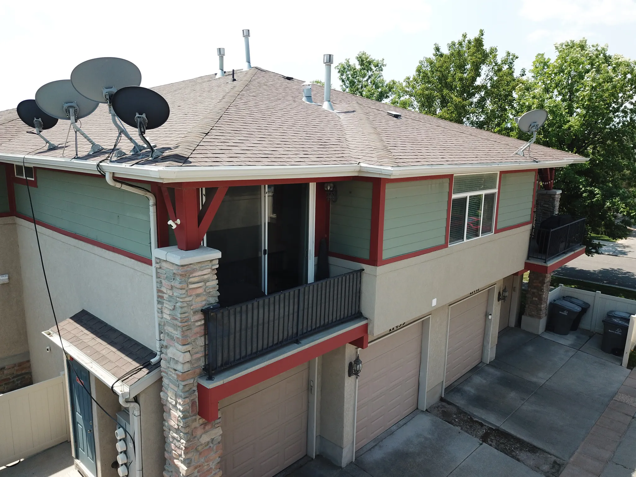 Multi-level exterior featuring a composite shingle roof, horizontal siding, and stucco finishes
