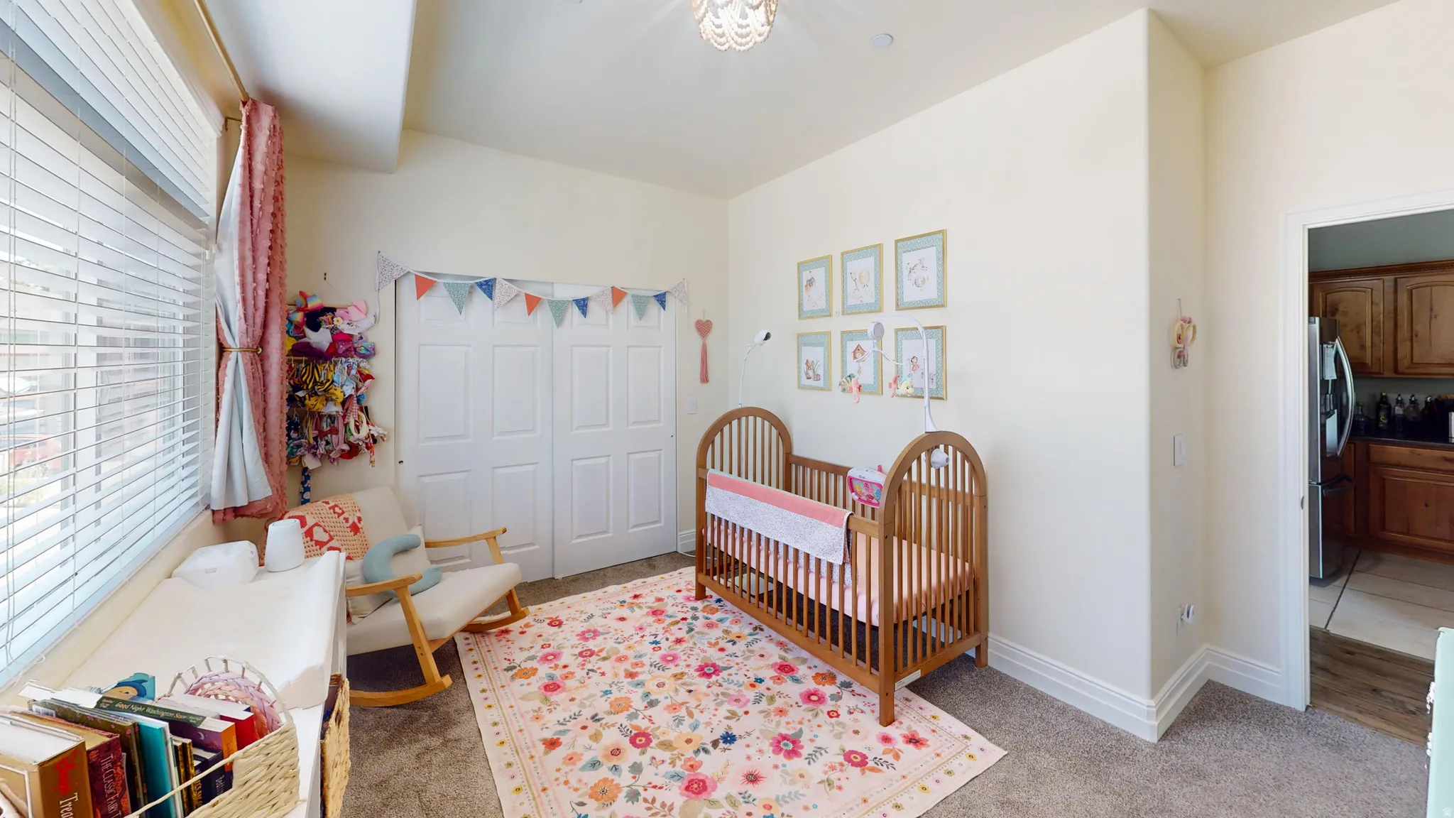 Carpeted interior room with light-colored walls and a vaulted ceiling