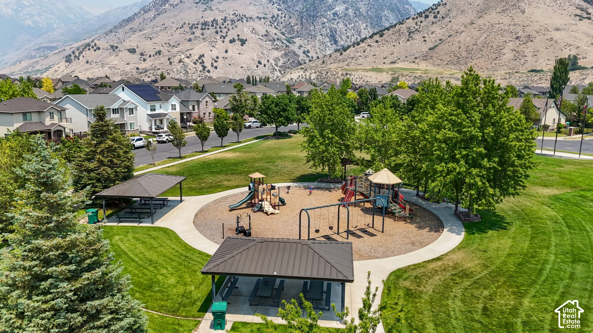 Community park featuring an expansive playground area with swings and multiple slides