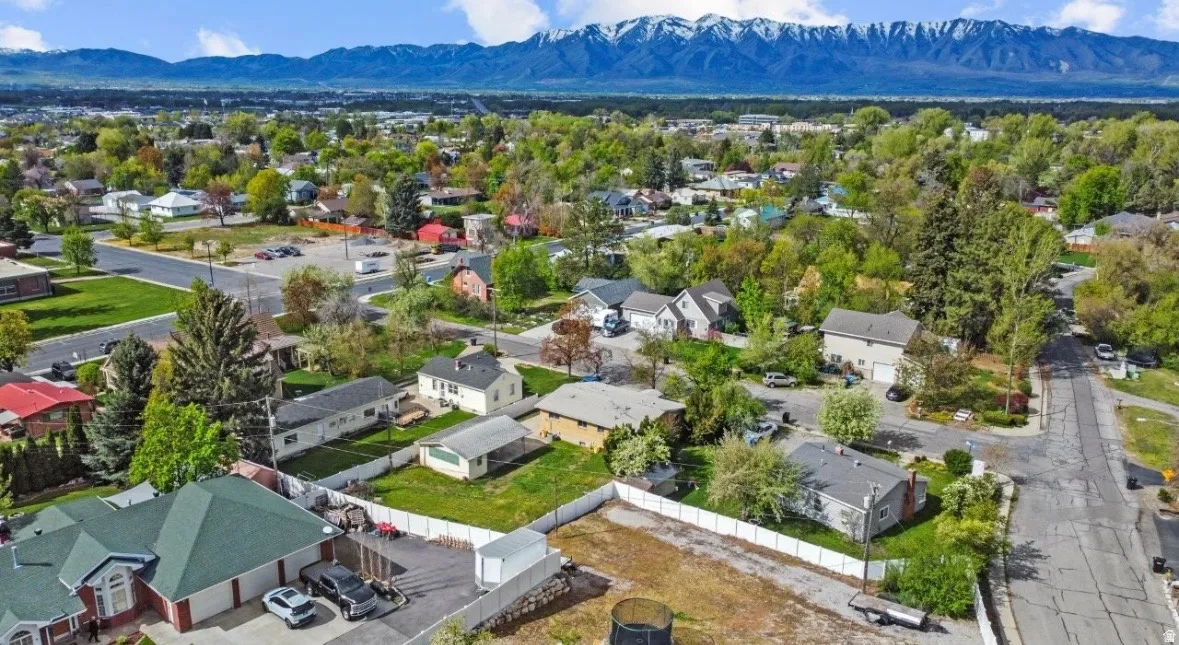 Aerial view showcasing residential properties with a mountainous backdrop