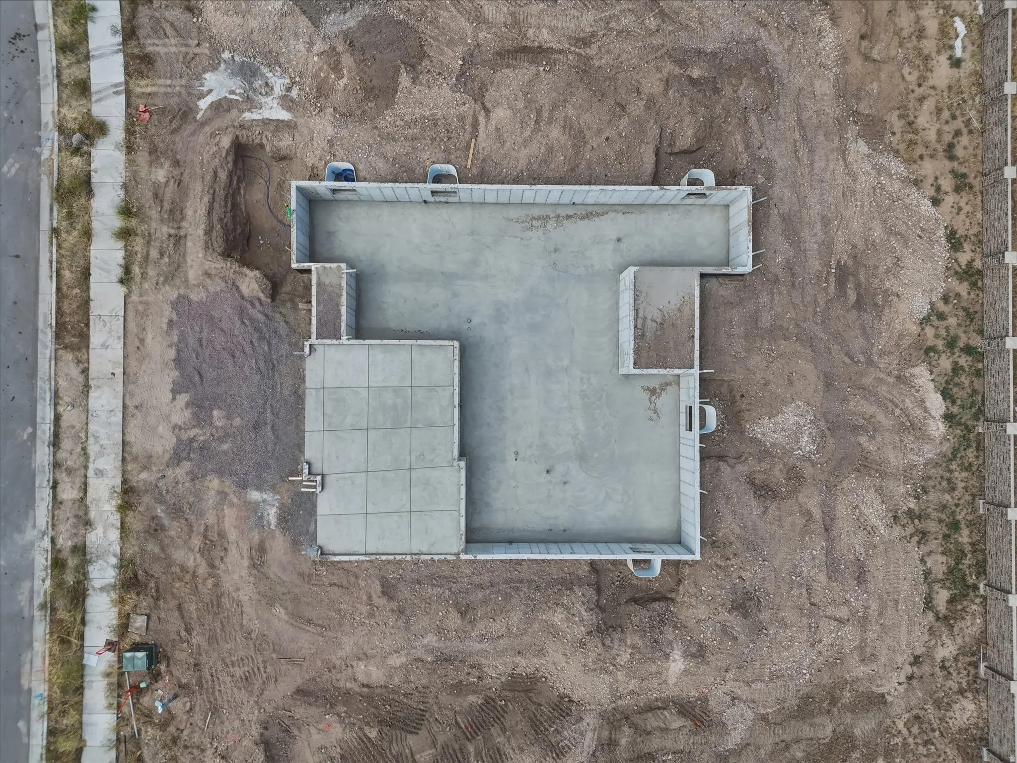 Concrete foundation with perimeter wall framing, showcasing a multi-level layout
