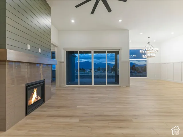 Contemporary fireplace with a shiplap accent wall and wood mantel